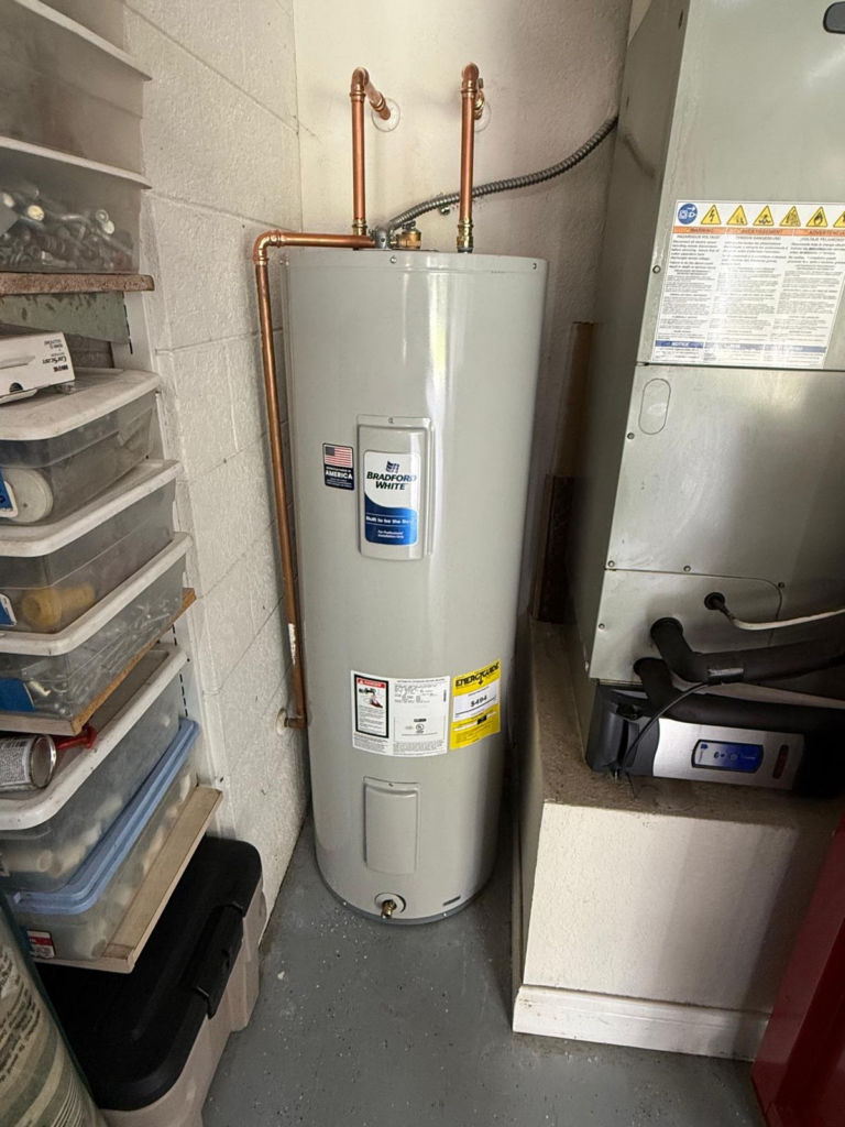 Bradford White residential electric water heater installed with new copper plumbing connections by Fast Track Plumbing in Tampa.